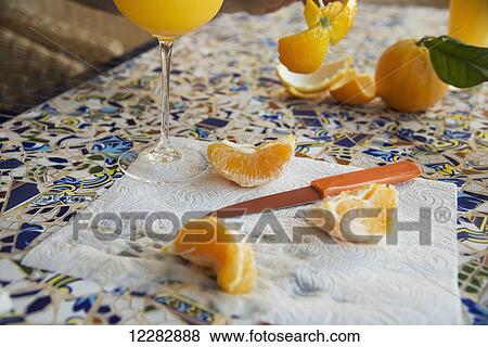 Orange peeled and cut into slices and a glass of orange juice; Fornalutz, Mallorca View Large Photo Image Stock Photo - Orange peeled and cut into slices and a glass of orange juice; Fornalutz, Mallorca. Fotosearch