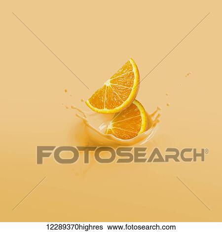 Stock Photograph - Orange slices splashing into orange liquid; Toronto, Ontario, Canada. Fotosearch