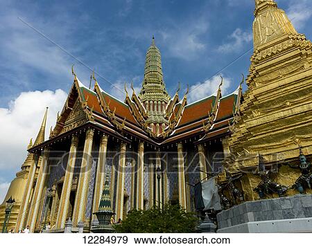 Stock Photo - Ornate building and gold structures with statues, Temple of the Emerald Buddha (Wat Phra Kaew); Bangkok, Thailand. Fotosearch