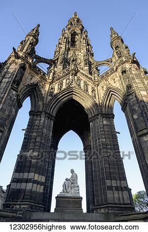 Stock Photograph - Ornate facade of an arched niche with Scott Monument, Princes Street Gardens; Edinburgh, Scotland. Fotosearch