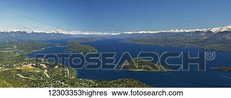 Panoramic view of a large lake in Patagonia, with snow-capped mountains and blue sky; Argentina View Large Photo Image Stock Photograph - Panoramic view of a large lake in Patagonia, with snow-capped mountains and blue sky; Argentina. Fotosearch