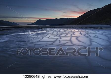 Stock Photograph - Patterns in the mudflats at dusk near Peterson Creek on the Turnagain Arm south of Girdwood, Alaska.. Fotosearch