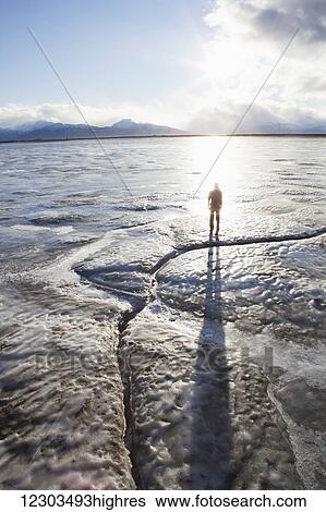 Stock Photograph - Person silhouetted on the beach, Homer Spit, Southcentral Alaska. Fotosearch