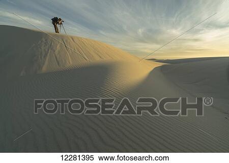 Person taking photos in the white sand desert of Namakwaland National Park; South Africa View Large Photo Image Stock Photography - Person taking photos in the white sand desert of Namakwaland National Park; South Africa. Fotosearch