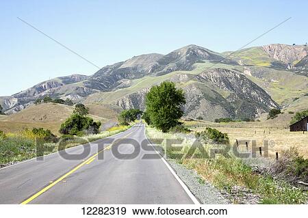 Stock Photo - Perspective road with mountains in the background; California, United States of America. Fotosearch