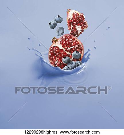 Pomegranate and blueberries splashing into a blue liquid; Toronto, Ontario, Canada View Large Photo Image Stock Photograph - Pomegranate and blueberries splashing into a blue liquid; Toronto, Ontario, Canada. Fotosearch
