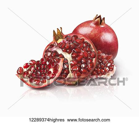 Stock Photograph - Pomegranate and opened pomegranate to show seeds; Toronto, Ontario, Canada. Fotosearch