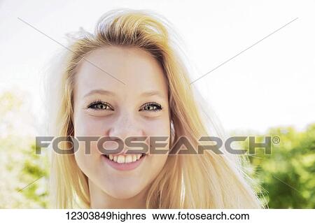 Portrait of a beautiful young woman with long blond hair in a city park; Edmonton, Alberta, Canada View Large Photo Image Stock Photograph - Portrait of a beautiful young woman with long blond hair in a city park; Edmonton, Alberta, Canada. Fotosearch