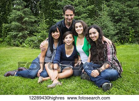 Portrait of a family with three daughters; Sherwood Park, Alberta, Canada View Large Photo Image Stock Photograph - Portrait of a family with three daughters; Sherwood Park, Alberta, Canada. Fotosearch