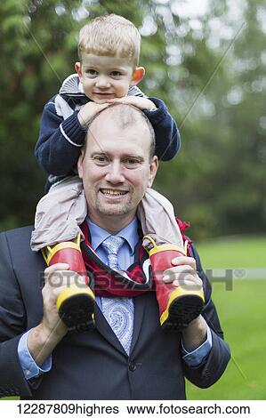 Portrait of a father and son in Bear Creek Park; Surrey, British Columbia, Canada View Large Photo Image Stock Photograph - Portrait of a father and son in Bear Creek Park; Surrey, British Columbia, Canada. Fotosearch
