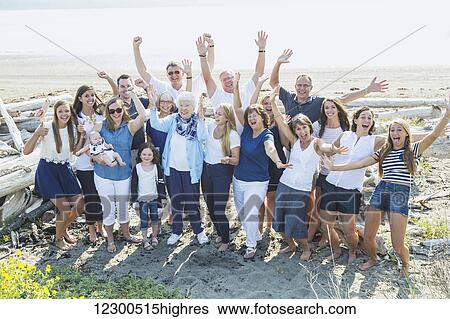 Stock Photograph - Portrait of a large family on a beach along the coast; Fox Spit, Whidbey Island, Washington, United States of America. Fotosearch