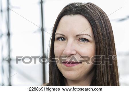 Stock Photograph - Portrait of a mature business woman in the atrium of an office building; Edmonton, Alberta, Canada. Fotosearch