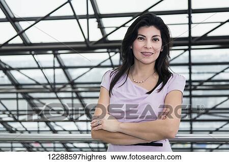 Stock Photograph - Portrait of a mature business woman in the atrium of an office building; Edmonton, Alberta, Canada. Fotosearch