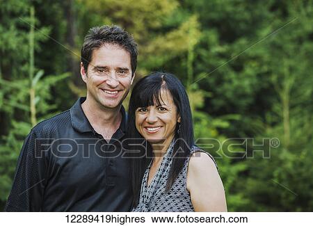 Stock Photograph - Portrait of a mature couple outdoors in autumn; Sherwood Park, Alberta, Canada. Fotosearch