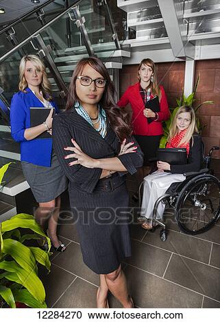 Portrait of a professional business woman with her team in the lobby of an office, one of which is a paraplegic in a wheelchair; St. Albert, Alberta, Canada View Large Photo Image Stock Image - Portrait of a professional business woman with her team in the lobby of an office, one of which is a paraplegic in a wheelchair; St. Albert, Alberta, Canada. Fotosearch
