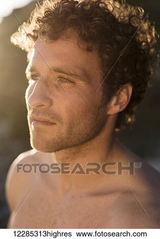 Portrait of a shirtless man with curly hair; Tarifa, Cadiz, Andalusia, Spain View Large Photo Image Stock Photograph - Portrait of a shirtless man with curly hair; Tarifa, Cadiz, Andalusia, Spain. Fotosearch