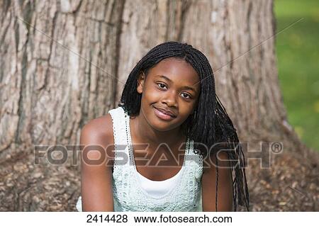 Stock Photo - Portrait of a teenager in a park; Edmonton, Alberta, Canada. Fotosearch