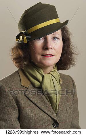 Portrait of a woman with brunette hair wearing a green felt hat and scarf; Caldecott, England View Large Photo Image Stock Photograph - Portrait of a woman with brunette hair wearing a green felt hat and scarf; Caldecott, England. Fotosearch