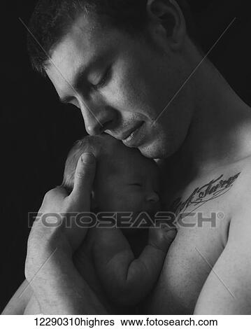 Stock Photograph - Portrait of a young father with baby boy; Alberta, Canada. Fotosearch