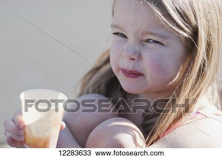 Portrait of a young girl making a funny face as she drinks a sour drink; Richmond, British Columbia, Canada View Large Photo Image Stock Image - Portrait of a young girl making a funny face as she drinks a sour drink; Richmond, British Columbia, Canada. Fotosearch