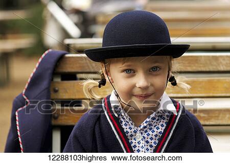 Stock Photograph - Portrait of a young girl wearing a school uniform; London, England. Fotosearch