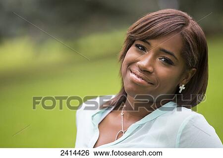 Portrait of a young woman in a park; Edmonton, Alberta, Canada View Large Photo Image Stock Photograph - Portrait of a young woman in a park; Edmonton, Alberta, Canada. Fotosearch
