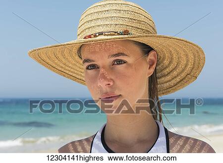 Portrait of a young woman on the beach wearing a sunhat; Tarifa, Cadiz, Andalusia, Spain View Large Photo Image Stock Photograph - Portrait of a young woman on the beach wearing a sunhat; Tarifa, Cadiz, Andalusia, Spain. Fotosearch