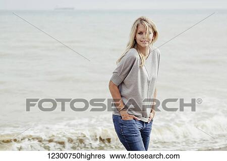 Portrait of a young woman with long, blond hair at the Atlantic Ocean; Hastings, Sussex, England View Large Photo Image Stock Photograph - Portrait of a young woman with long, blond hair at the Atlantic Ocean; Hastings, Sussex, England. Fotosearch