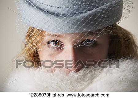 Portrait of a young woman with red hair in a blue veiled hat and white fur; Caldecott, England View Large Photo Image Stock Photograph - Portrait of a young woman with red hair in a blue veiled hat and white fur; Caldecott, England. Fotosearch