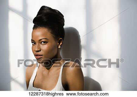 Portrait of an African Canadian woman leaning against a wall; Toronto, Ontario, Canada View Large Photo Image Stock Photograph - Portrait of an African Canadian woman leaning against a wall; Toronto, Ontario, Canada. Fotosearch