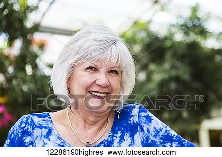 Stock Photograph - Portrait of an attractive mature woman at a shopping complex; St. Albert, Alberta, Canada. Fotosearch