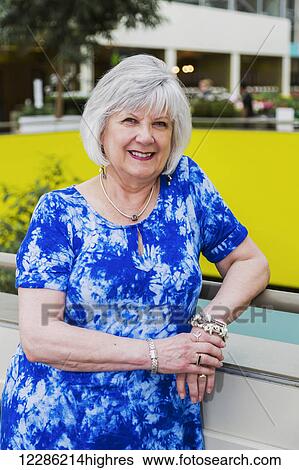 Portrait of an attractive mature woman at a shopping complex; St. Albert, Alberta, Canada View Large Photo Image Stock Photograph - Portrait of an attractive mature woman at a shopping complex; St. Albert, Alberta, Canada. Fotosearch