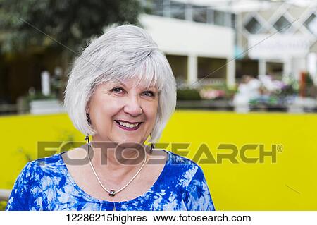 Portrait of an attractive mature woman at a shopping complex; St. Albert, Alberta, Canada View Large Photo Image Stock Photograph - Portrait of an attractive mature woman at a shopping complex; St. Albert, Alberta, Canada. Fotosearch
