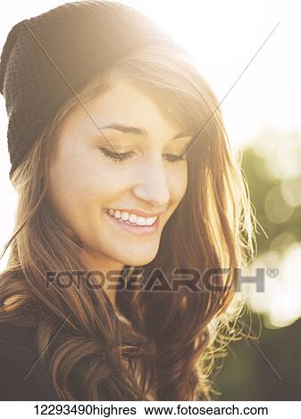 Stock Photograph - Portrait of Beautiful Happy Young Woman Smiling, Warm soft color tone. Fotosearch