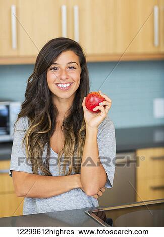 Stock Photograph - Portrait of beautiful woman with an apple, Healthy Lifestyle Concept. Fotosearch