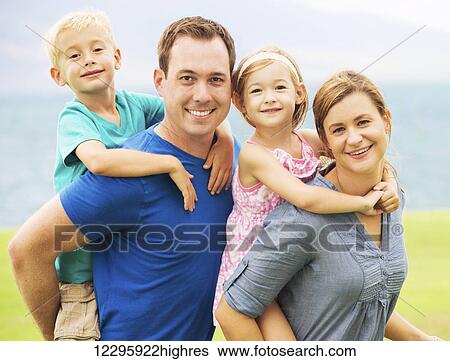 Stock Photograph - Portrait of Happy Family Outside. Fotosearch