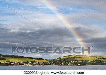 Stock Photograph - Rainbow in the sky over Chanonry Point; Moray Firth, Scotland. Fotosearch