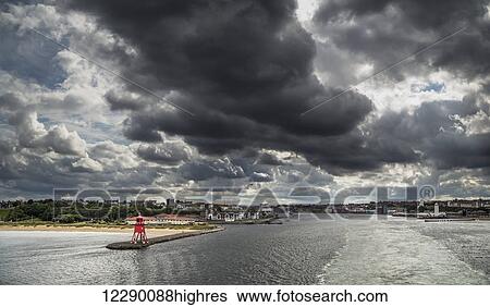 Red Herd Groyne lighthouse at the end of a pier under storm clouds; South Shields, Tyne and Wear, England View Large Photo Image Stock Photograph - Red Herd Groyne lighthouse at the end of a pier under storm clouds; South Shields, Tyne and Wear, England. Fotosearch