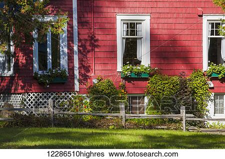 Stock Photograph - Red house with flower boxes; North Hatley, Quebec, Canada. Fotosearch