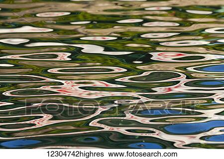 Stock Photograph - Reflections on the surface of water; Canada. Fotosearch