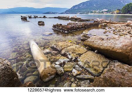 Stock Photograph - Rock and debris along the shoreline; Corinth, Greece. Fotosearch