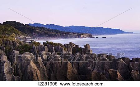 Stock Photo - Rock formations at sunset; Punakaiki, South Island, New Zealand. Fotosearch