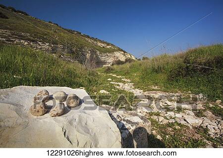 Stock Photograph - Rocks, grass and blue sky in the Valley of Elah; Israel. Fotosearch