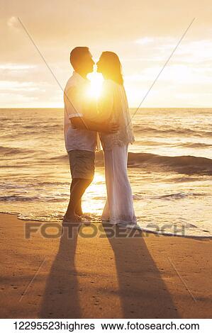 Romantic Mature Couple Kissing at Sunset on the Beach View Large Photo Image Stock Photograph - Romantic Mature Couple Kissing at Sunset on the Beach. Fotosearch