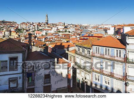 Rooftops of houses and a tower in the distance against a blue sky; Oporto, Portugal View Large Photo Image Stock Photograph - Rooftops of houses and a tower in the distance against a blue sky; Oporto, Portugal. Fotosearch