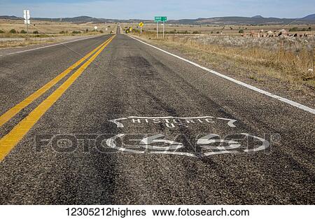 Stock Photograph - Route 66 logo painted on the highway; Arizona, United States of America. Fotosearch