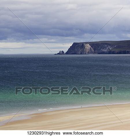 Stock Photograph - Rugged cliffs and sea stacks along the coast in the Highlands; Scotland. Fotosearch