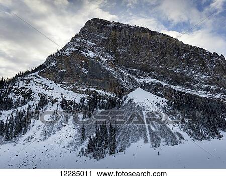 Rugged mountain with snow in winter; Lake Louise, Alberta, Canada View Large Photo Image Stock Image - Rugged mountain with snow in winter; Lake Louise, Alberta, Canada. Fotosearch