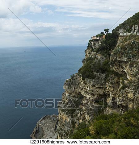 Stock Photograph - Rugged rock cliff along the Amalfi coast; Amalfi, Italy. Fotosearch