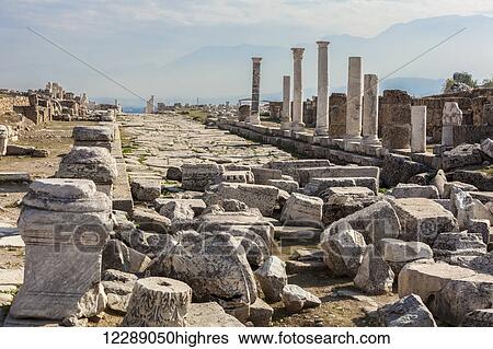 Stock Photograph - Ruins of stone columns at a biblical site; Laodicea, Turkey. Fotosearch
